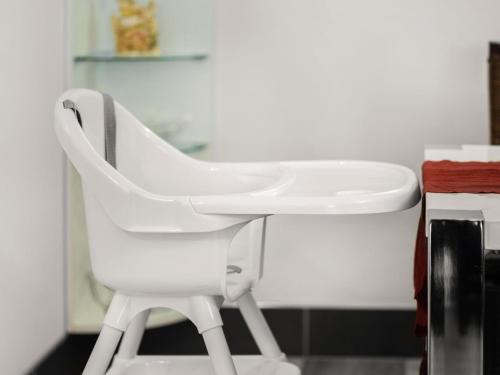 a white chair sitting next to a sink at Elegant Apartment, Grevesmühlen in Grevesmühlen