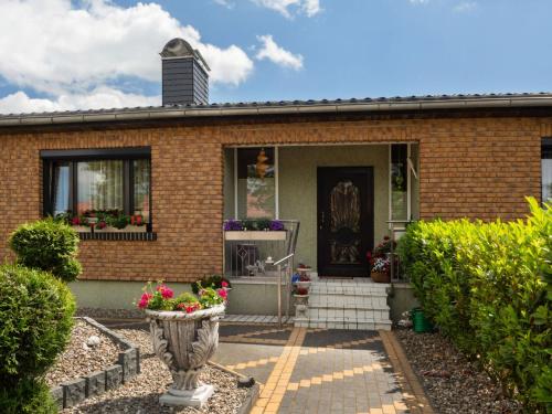 a brick house with a vase of flowers in front of it at Elegant Apartment, Grevesmühlen in Grevesmühlen