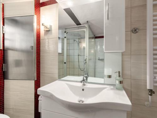 a bathroom with a white sink and a shower at Elegant Apartment, Grevesmühlen in Grevesmühlen