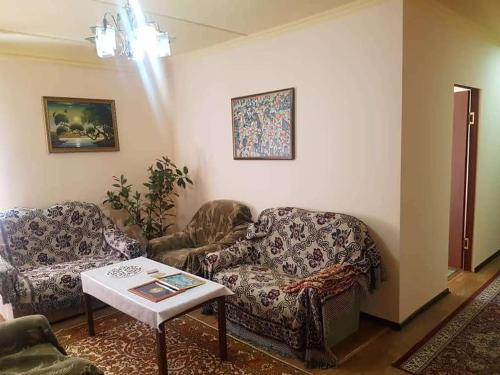 a living room with two chairs and a table at RAHAT Guest House & Hostel in Toktogul in Toktogul