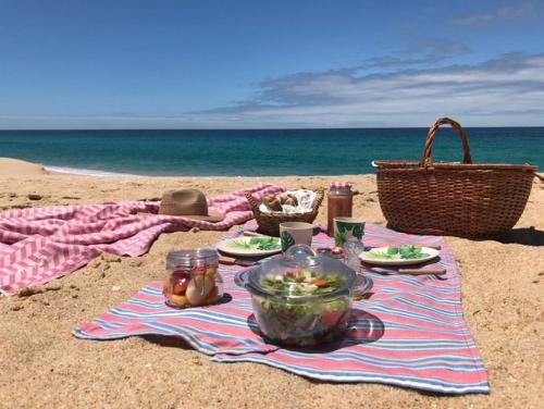 a picnic on a blanket on the beach at Ponte Pedra - Melides Country House Adults Only in Melides