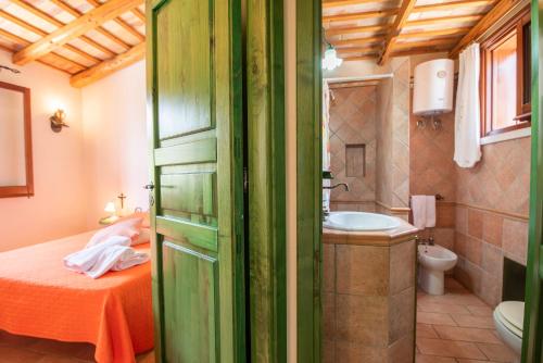 a bathroom with a bed and a sink and a toilet at Baglio Cracchiolo, "Casa Maria" in San Vito lo Capo