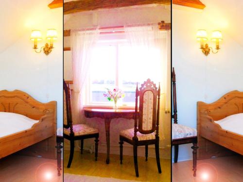 a bedroom with a table and chairs and a window at Kullabygdens Bed & Breakfast Höganäs in Jonstorp