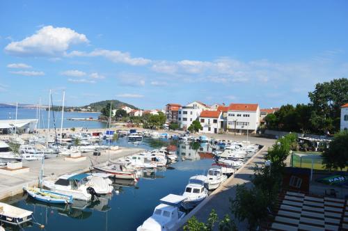 a bunch of boats are docked in a marina at Central Apartments Preko in Preko