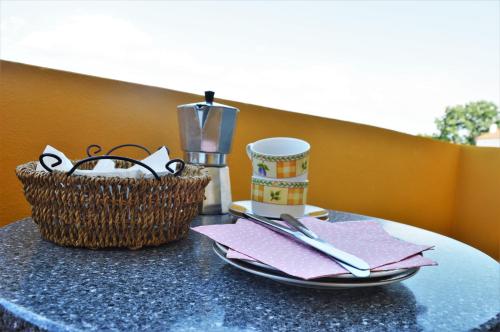 a table with a cup and a basket on it at Central Apartments Preko in Preko