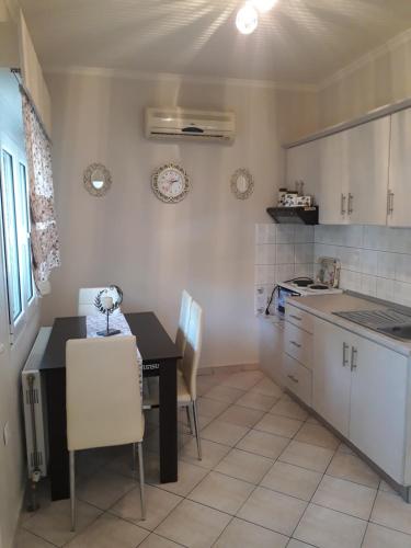 a kitchen with a table and a table and chairs at Villa Elia in Skala Sotiros