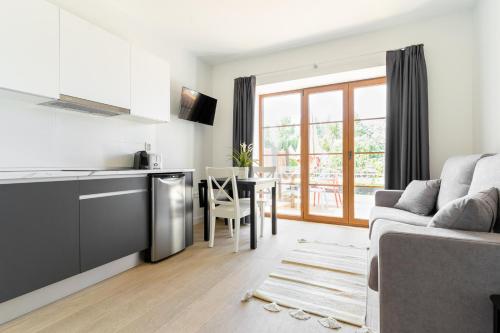 a kitchen and living room with a couch and a table at Jardines Villaverde in Villaverde de Pontones