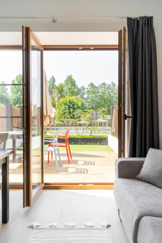 a living room with a couch and a sliding glass door at Jardines Villaverde in Villaverde de Pontones