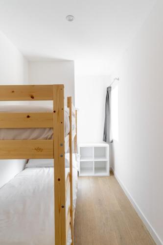 a bedroom with two bunk beds and white walls at Jardines Villaverde in Villaverde de Pontones