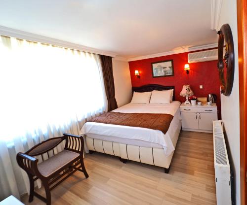 a bedroom with a large bed and a chair at The Sunrise Hotel in Istanbul