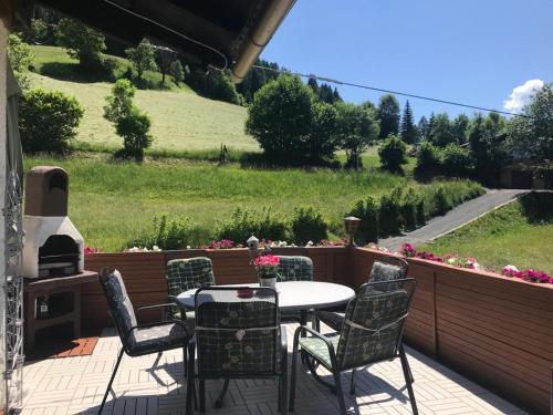 a patio with a table and chairs and a grill at Landhaus Schönblick in Radenthein