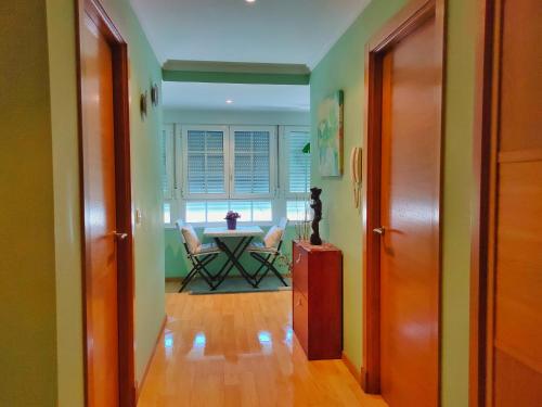 a hallway with a table and chairs in a room at A Casiña do Patio in Quiroga