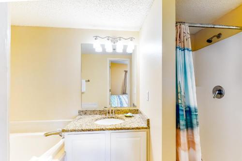 a bathroom with a sink and a mirror at Tropic Isl 501 in Gulf Shores