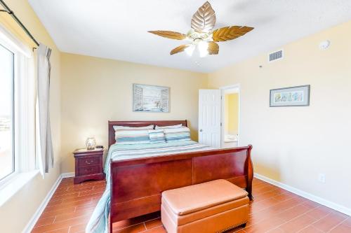 a bedroom with a bed and a ceiling fan at Tropic Isl 501 in Gulf Shores
