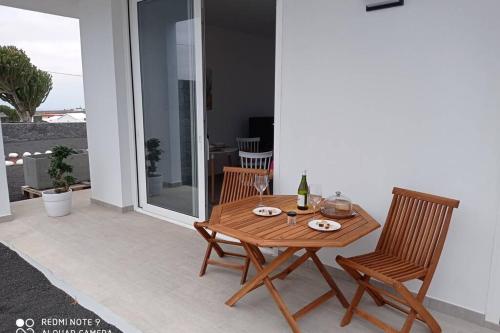 a wooden table and two chairs on a patio at Precioso apartamento con terraza en Teguise in Teguise