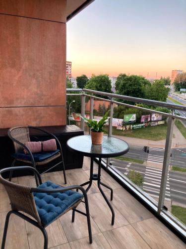 a balcony with a table and chairs and a view at Apartament Centrum Bocian in Białystok