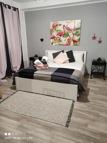 a bedroom with a large bed with pink pillows at B&B Marsà in Marzamemi