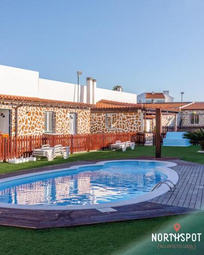 a swimming pool in the yard of a building at NorthSpot in Nazaré
