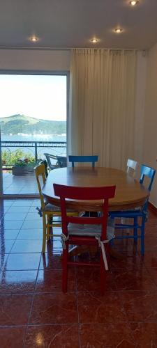 a table and chairs with a view of a balcony at Casa lui Marc in Orşova