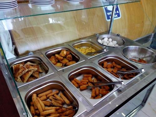 a buffet filled with trays of food on a counter at Dempa Hotel in Istanbul