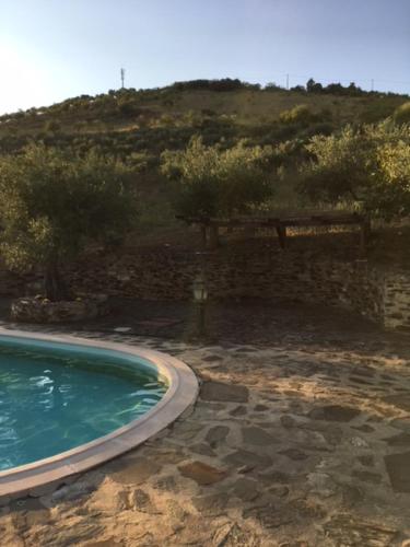 a swimming pool with a mountain in the background at Quinta da Vela in Meirinhos
