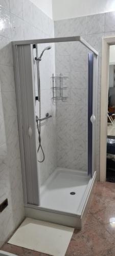 a shower with a glass door in a bathroom at Jajo in Brindisi