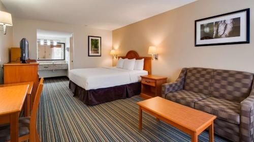 a hotel room with a bed and a couch at Best Western of Murphy in Murphy