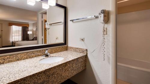 a bathroom with a sink and a mirror at Best Western of Murphy in Murphy