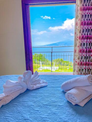a bedroom with a bed with a view of the ocean at ANTICA TENUTA CELOTTO in Vico Equense