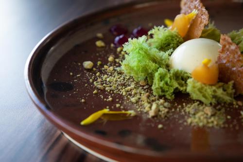 a bowl of food with broccoli and eggs on a table at The George in Christchurch