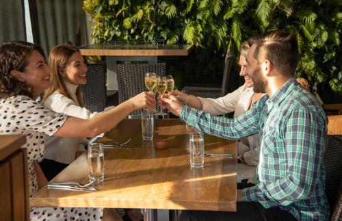 a group of people sitting around a table with glasses of champagne at The George in Christchurch