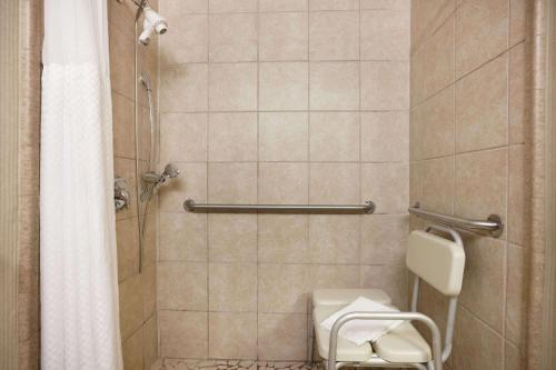a bathroom with a toilet and a shower at Ramada by Wyndham Newark/Wilmington in Newark