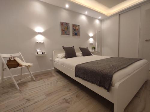 Habitación blanca con cama grande y escritorio. en Rual Centro apartamento en Ronda