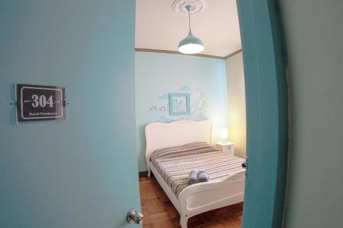 a bedroom with a bed and a clock on the wall at Hostal Providencia in Santiago