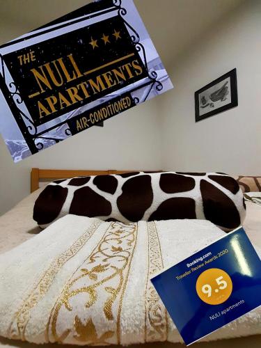 a book sitting on top of a bed with a movie sign at NULI apartments in Kruševo
