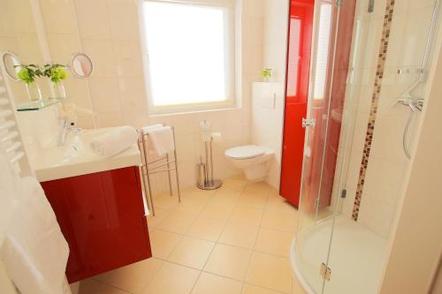 a bathroom with a toilet and a sink and a shower at Ostseeresidenz Schönberger Strand in Schönberger Strand