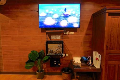 a flat screen tv hanging on a wall at Namtok Sarika Resotel in Nakhon Nayok