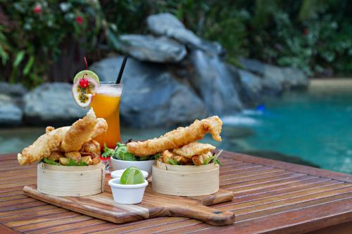 a tray of food and a drink on a table at Port Douglas Plantation Resort in Port Douglas