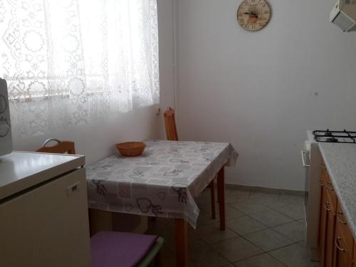 a kitchen with a table with a table cloth on it at Szeki Apartman in Balatonfüred