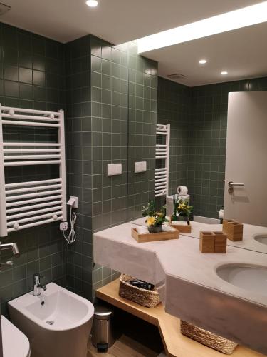 a bathroom with a sink and a toilet and a mirror at Victory Village 16F in Quinta do Lago