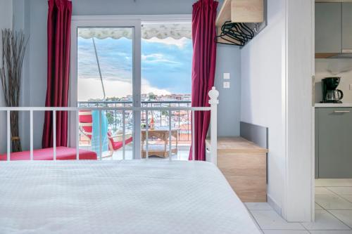 a bedroom with a bed and a balcony at Agnandi in Neos Marmaras