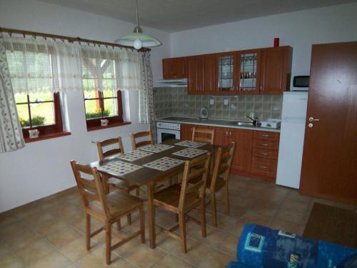 a kitchen with a table and chairs in a room at Apartmány U Lanovky in Rokytnice nad Jizerou