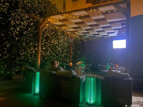 a person sitting in a chair in a room with lights at Hotel Bogart Milano in Milan