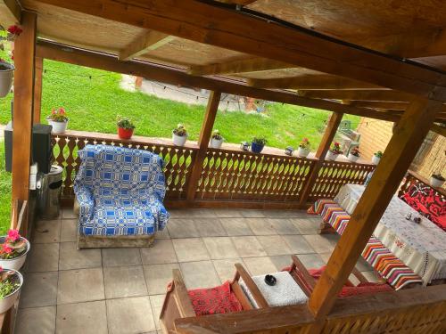 an overhead view of a porch with a couch and a chair at Floare de Maramures 1 in Vadu Izei