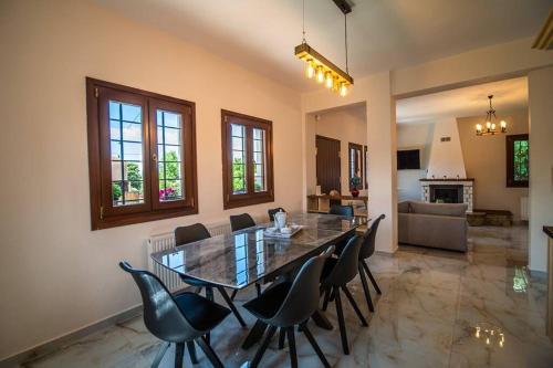 a large dining room with a table and chairs at Villa Clairy in Argalasti, Pelion in Argalasti
