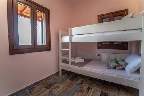 a bedroom with two bunk beds and a window at Villa Clairy in Argalasti, Pelion in Argalasti