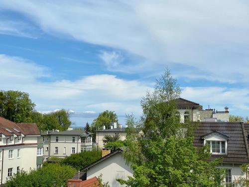 a group of houses in a city under a blue sky at Praia Apartments - 200 m do Plaży Apartament z balkonem i widokiem in Sopot