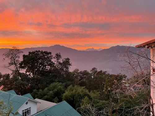 a sunset with a view of the mountains at Denzong Regency- Luxury Mountain Retreat Spa & Casino in Gangtok