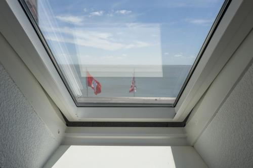 a window in a room with a view of the ocean at AKZENT Strandhotels Seestern, Delphin & Lachs in Wilhelmshaven