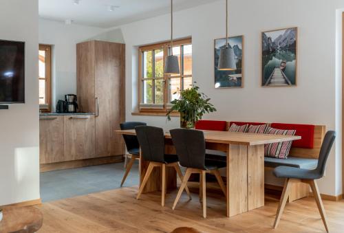 a kitchen and dining room with a wooden table and chairs at Luxury Chalets Gradenbach near Schladming in Haus im Ennstal
